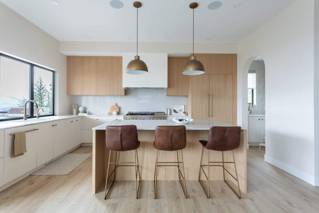 Custom kitchen with elegant archways and designer pendant lighting in modern Kamloops home