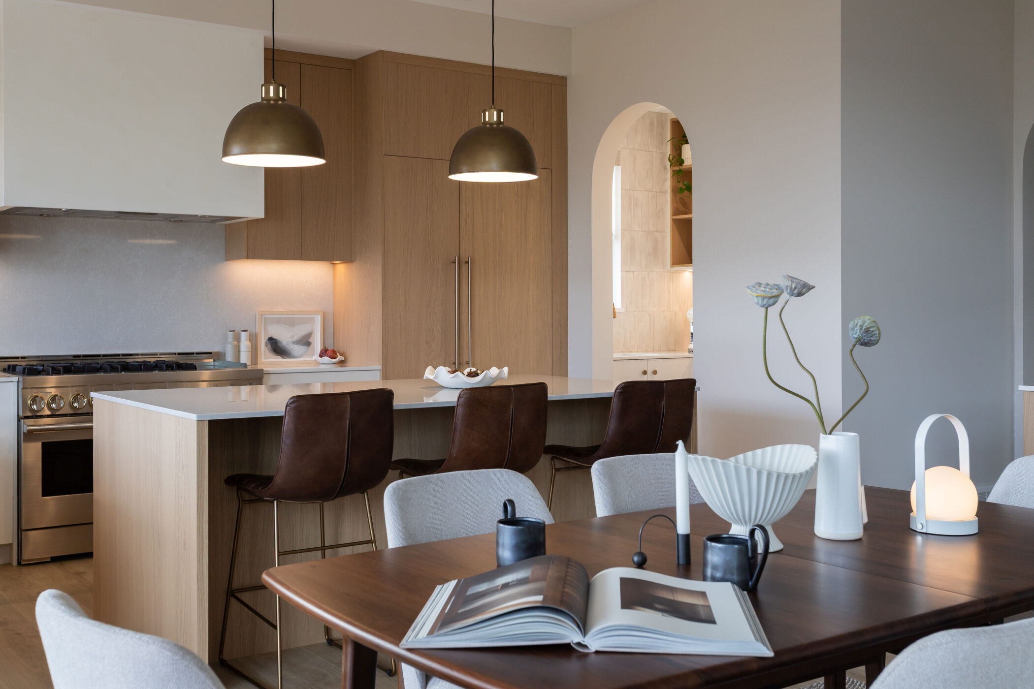 Modern kitchen design featuring soft arches and layered lighting in luxury Kamloops home