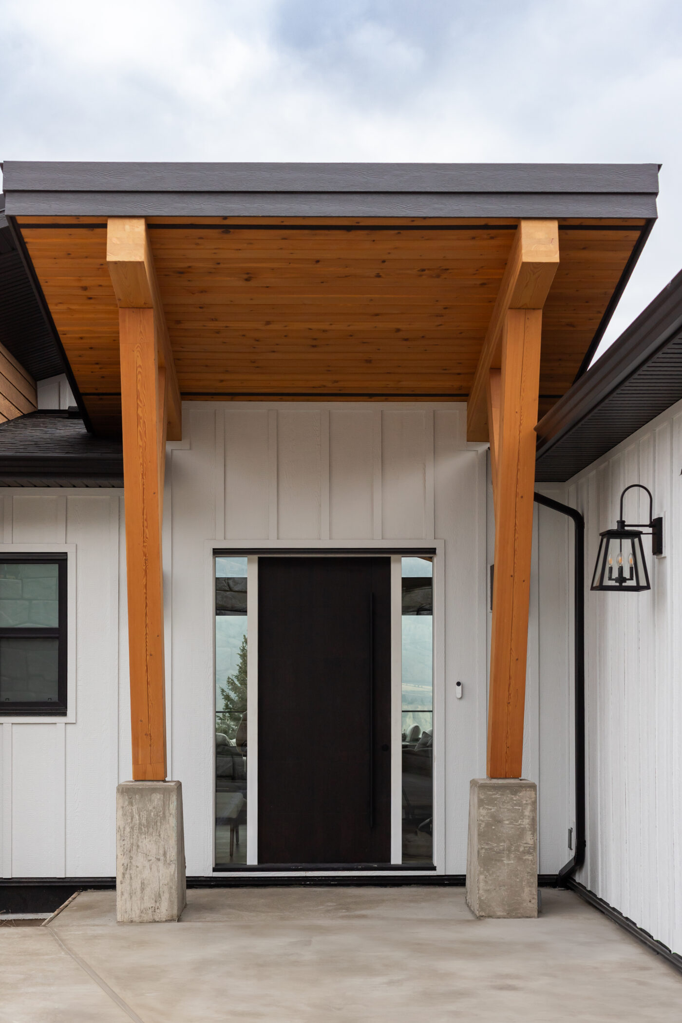 Modern entryway with warm wood accents in custom Kamloops home