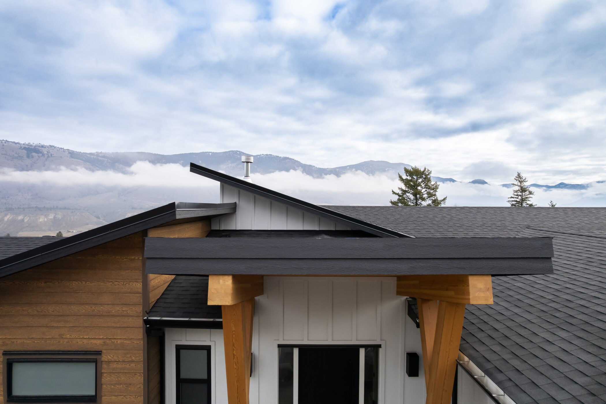 Modern back deck with dramatic roof lines in custom Kamloops mountain home