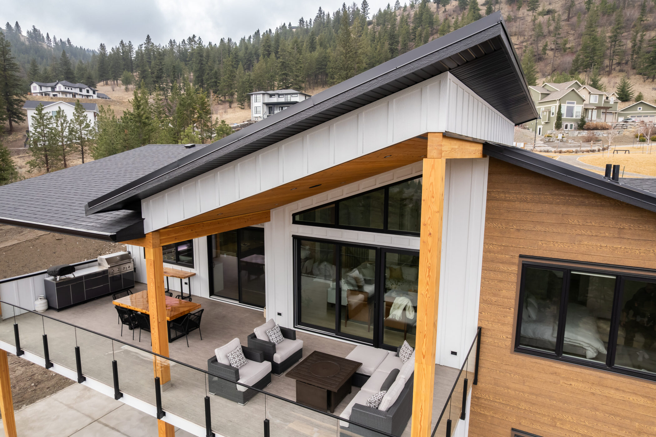 Contemporary covered deck with unique roof lines and scenic views in Kamloops