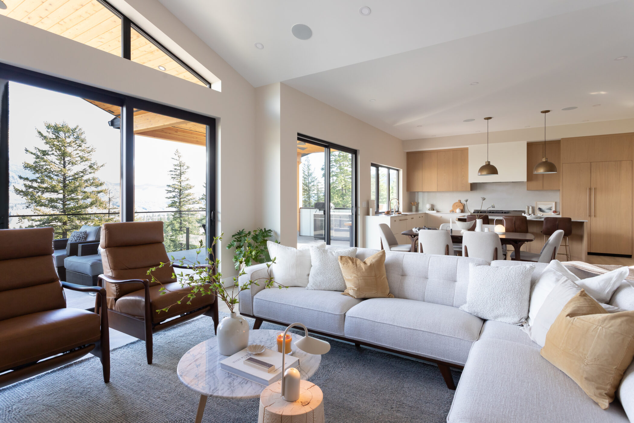 Spacious open-plan living room with large glass windows and vaulted ceilings in Kamloops