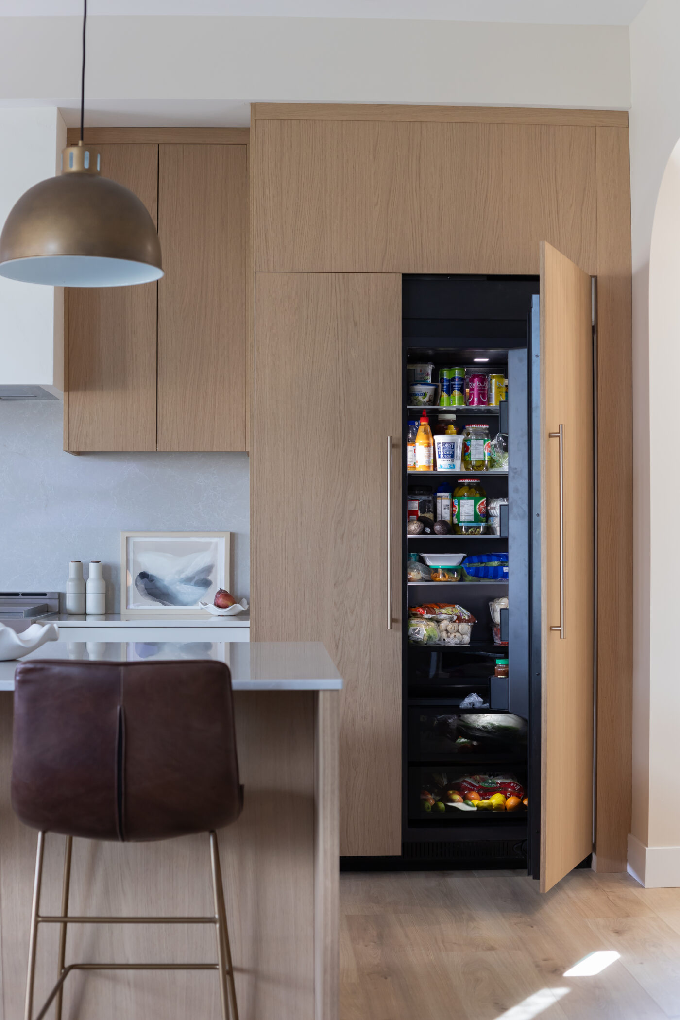 Sleek kitchen with panel-ready hidden refrigerator in luxury Kamloops home
